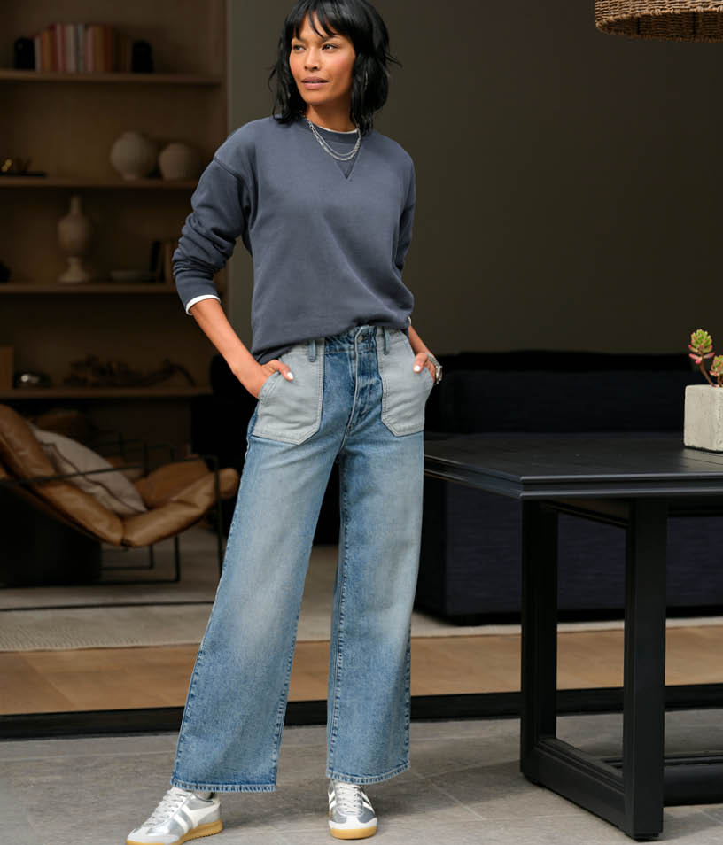 Image of woman wearing blue sweatshirt and blue jeans.