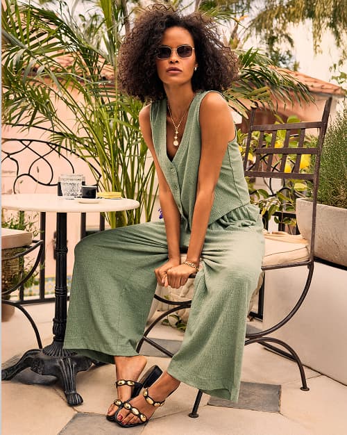 Image of woman wearing sage green matching tank and pant set