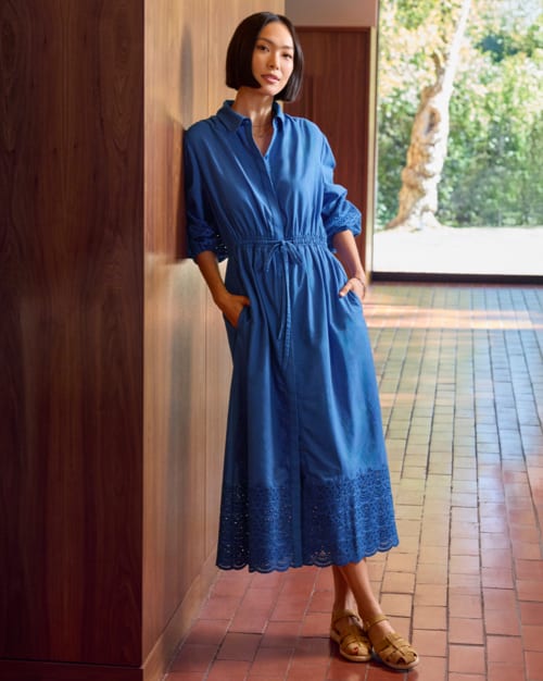 Image of woman wearing a long blue dress and brown sandals